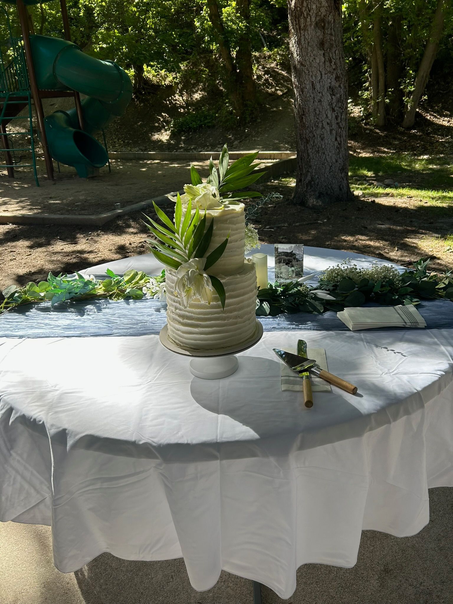Wedding cake table rental set up outdoors for a ceremony or reception