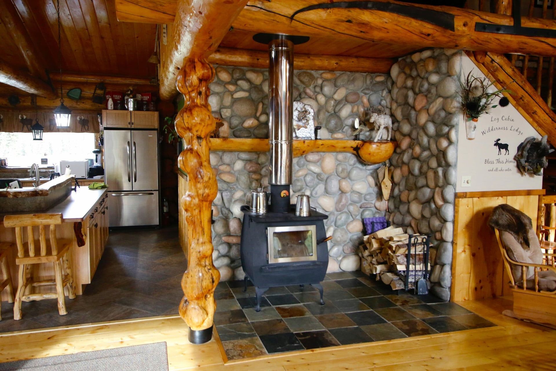 A log cabin with a wood stove in the middle of the room