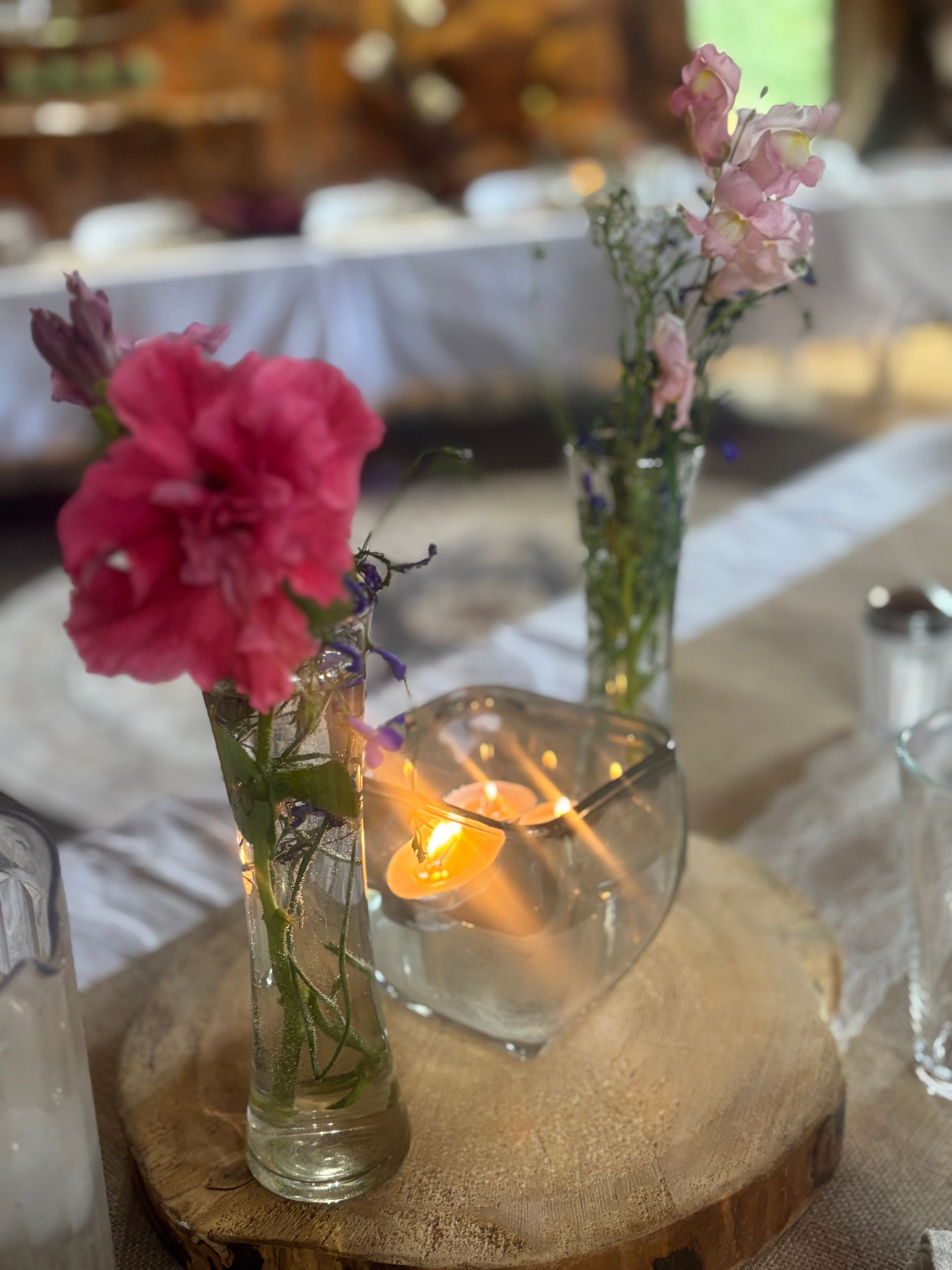 A person is walking through a snowy field in front of a mountain.