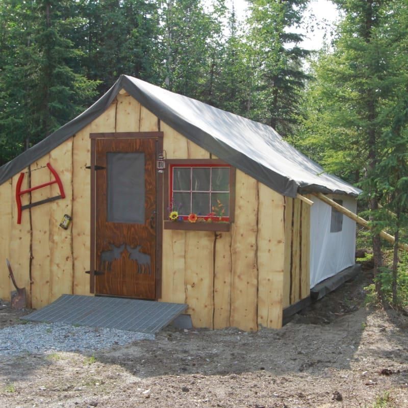 A small wooden house with the letter a painted on the side