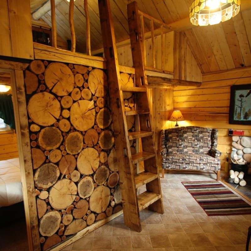 A room with a wooden wall and a ladder