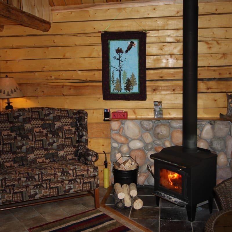 A living room with a couch and a wood stove