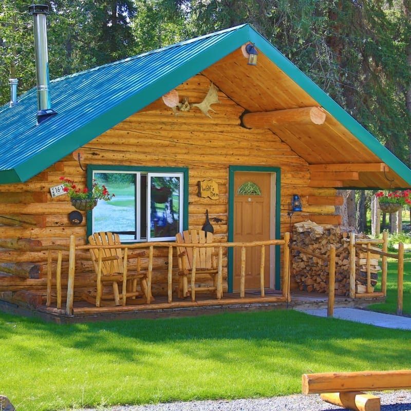 A small log cabin with a blue roof