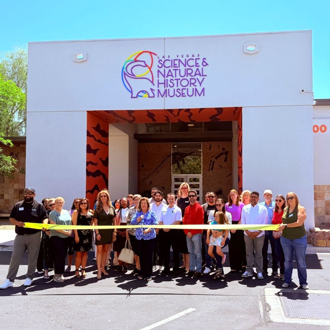 A group of people standing in front of las vegas science and natural history museum