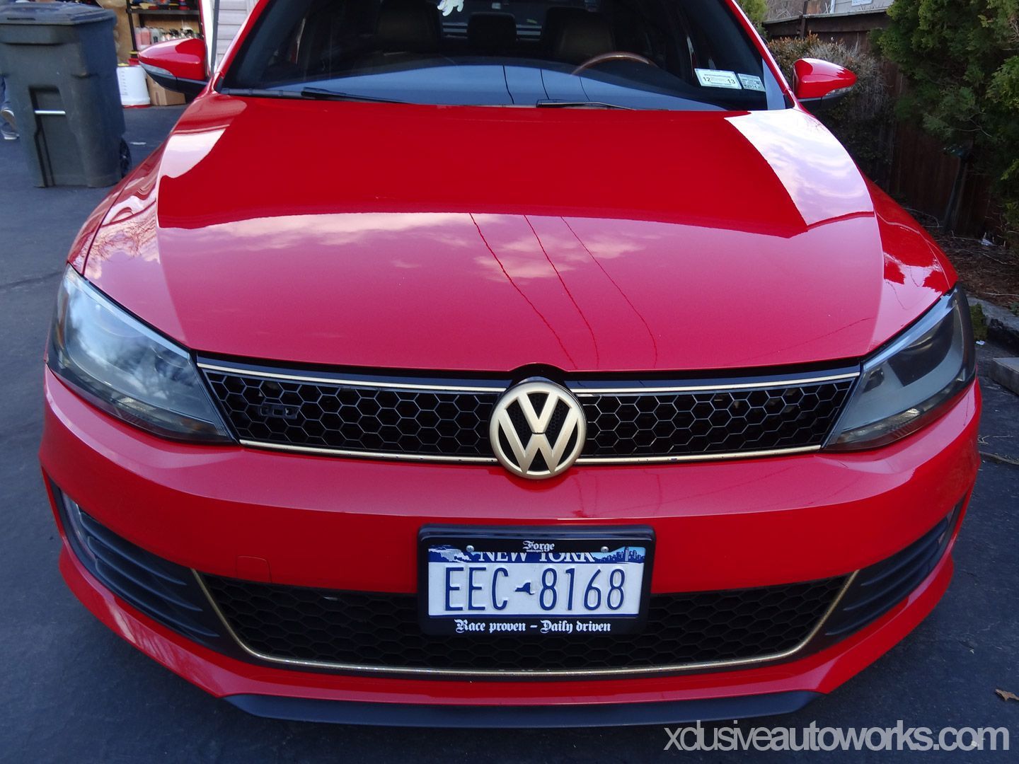A red volkswagen with a license plate that says fec-b168