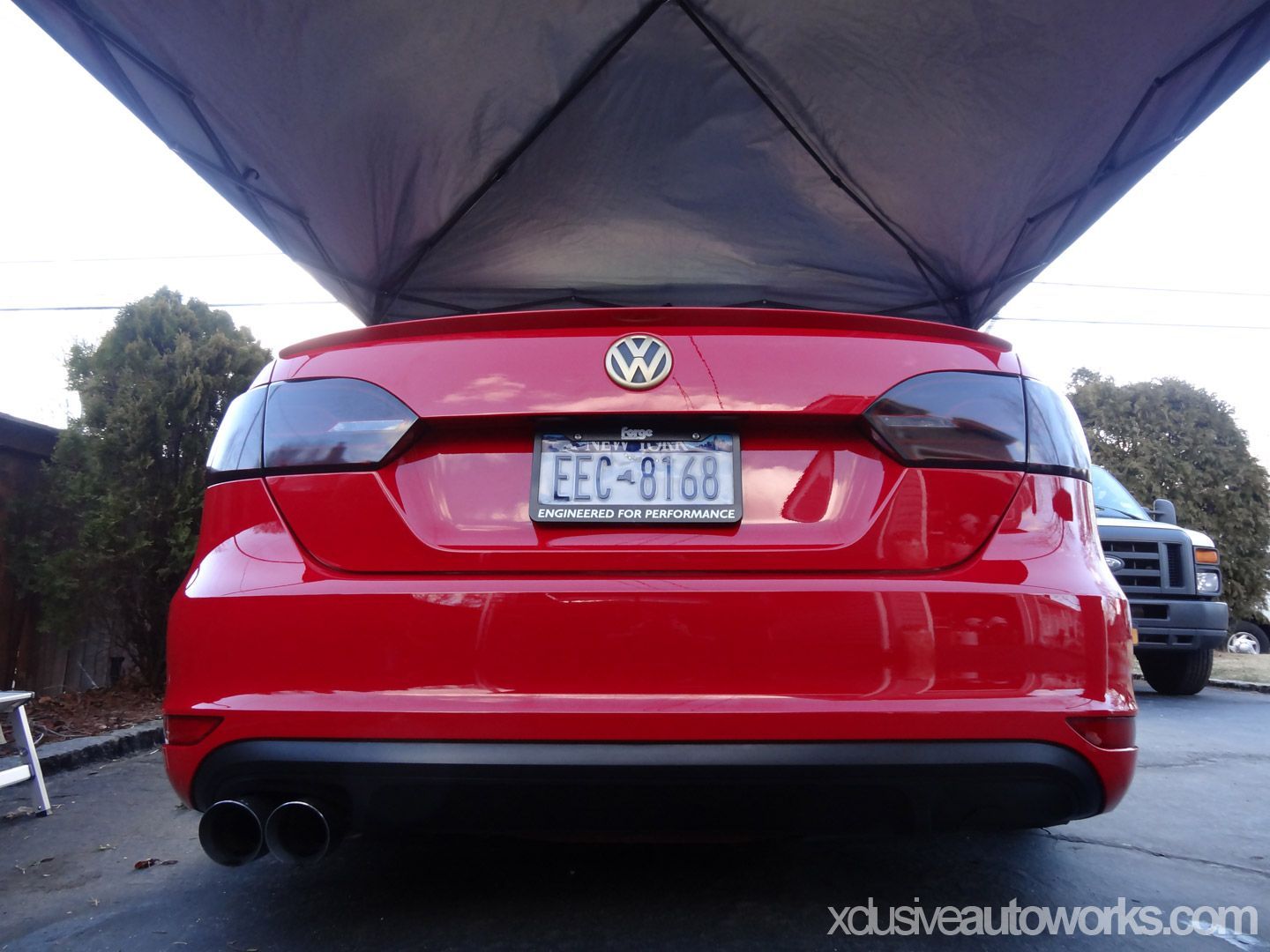 A red car with a license plate that says eec b168