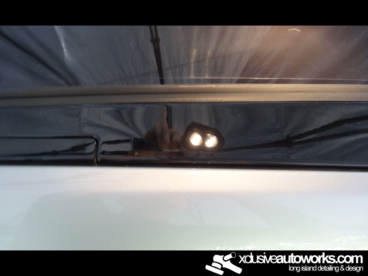 A picture of a car with the website xclusiveautoworks.com at the bottom