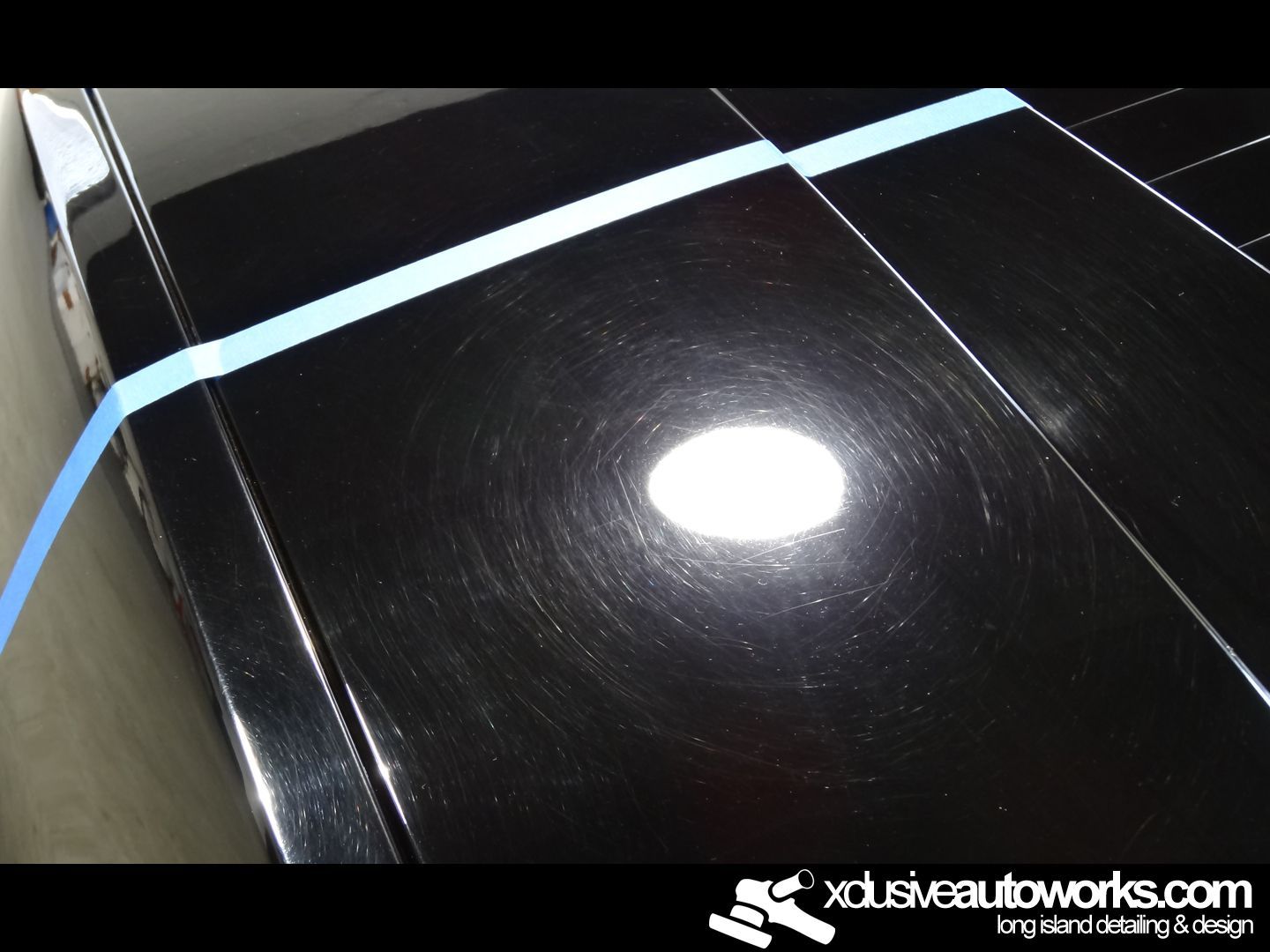 A black car is being polished by xdusveautoworks.com