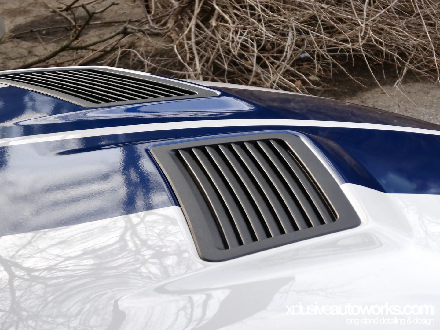 A close up of a hood vent on a car