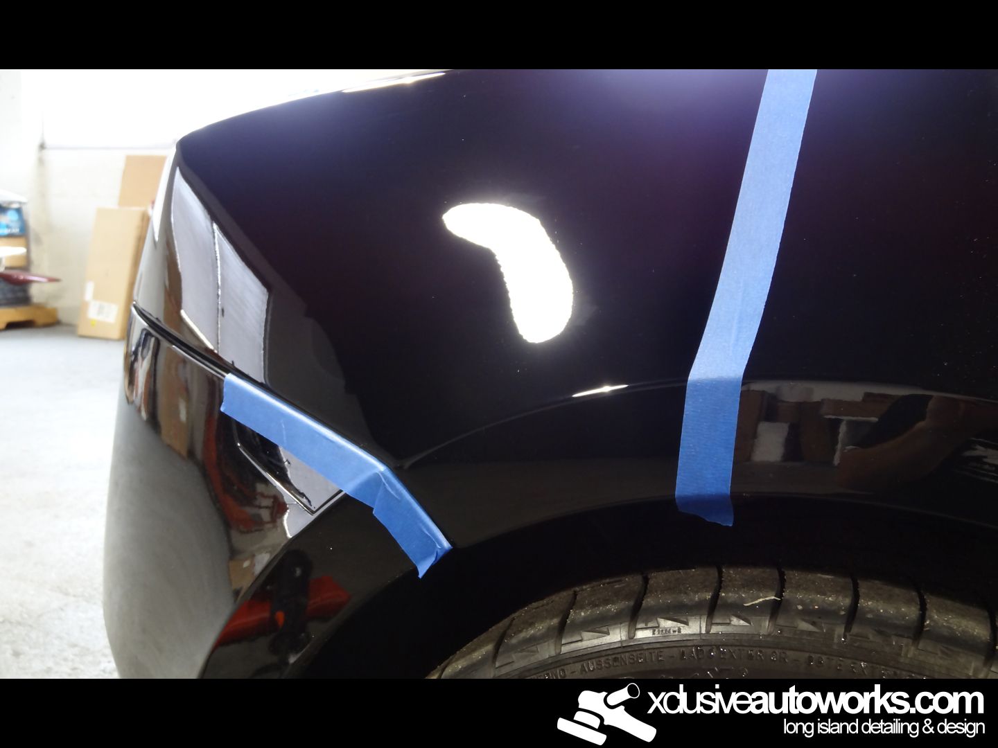 A close up of a car with xclusiveautoworks.com written on the bottom