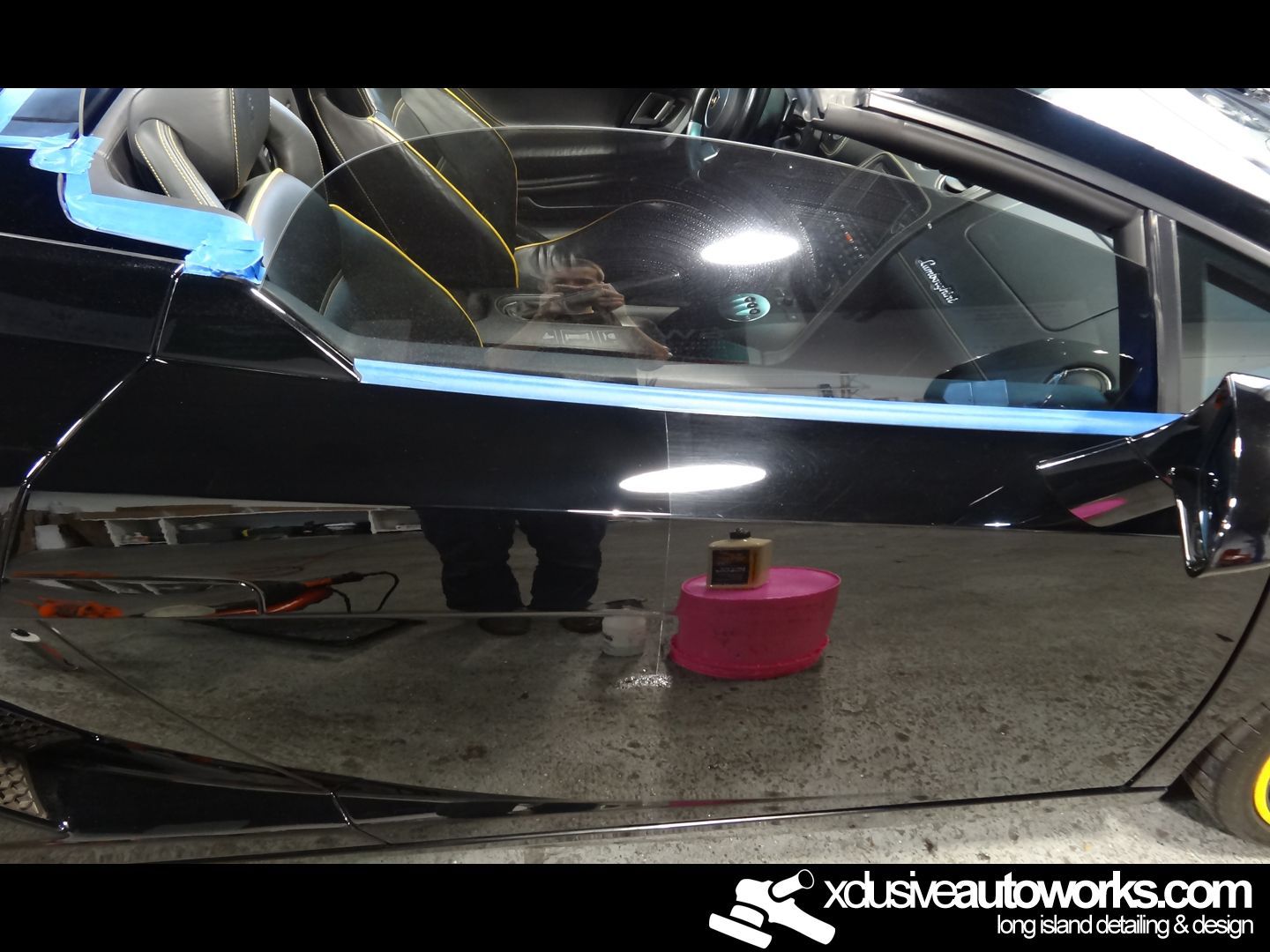 A black car is being polished by xdusveautoworks.com