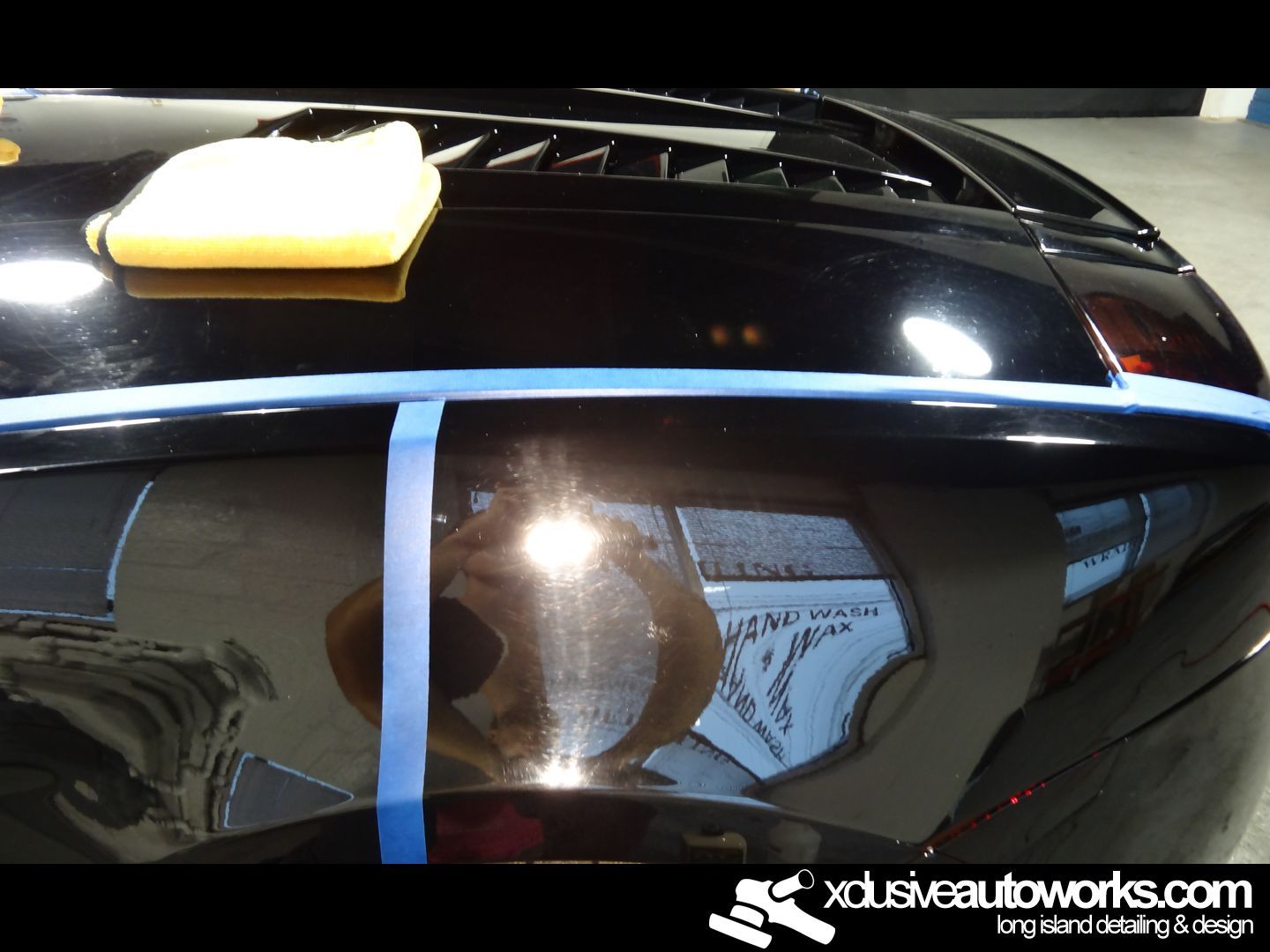 A black car is being polished by xdusveautoworks.com