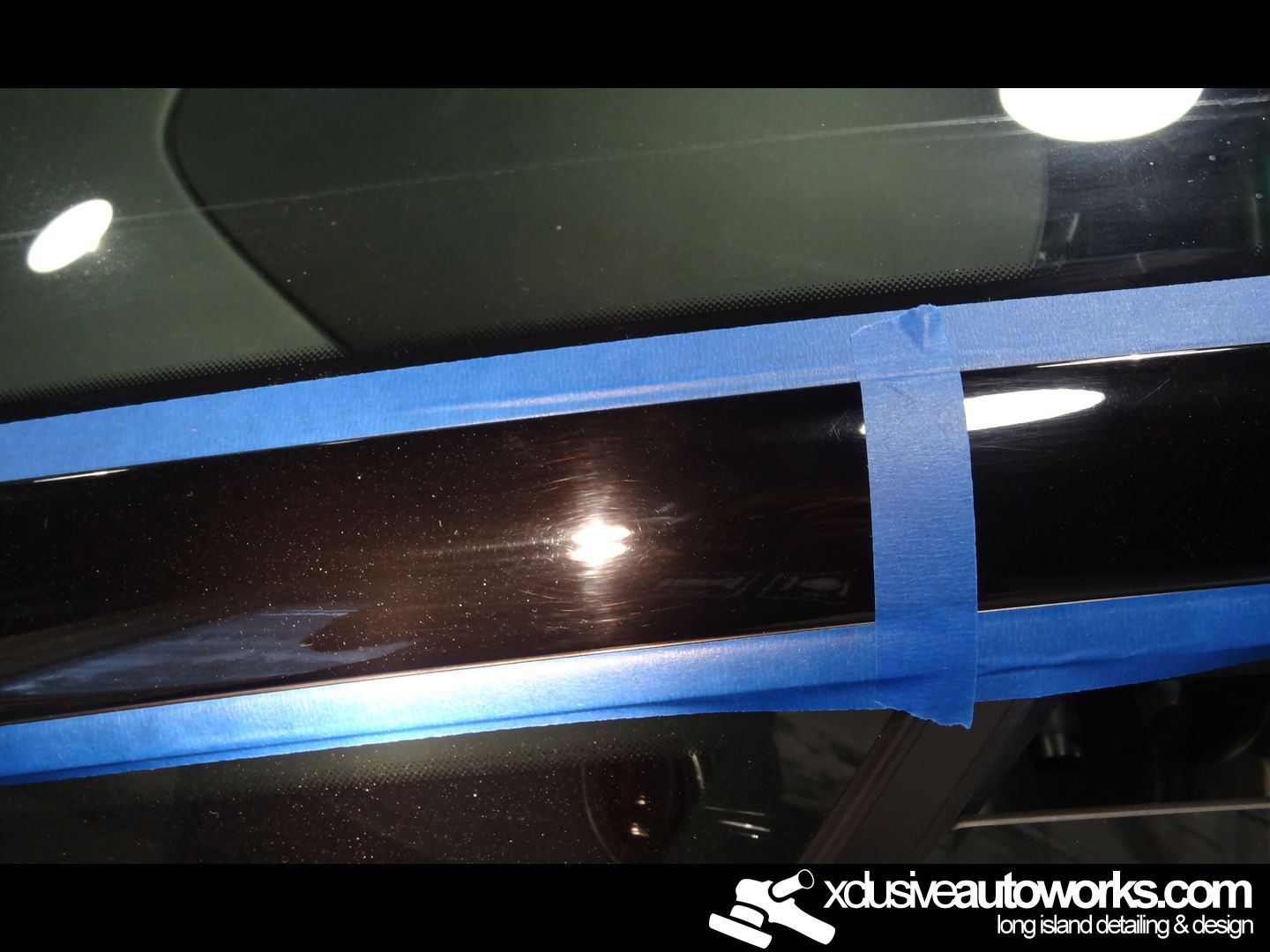 A close up of a car with xclusiveautoworks.com written on the bottom