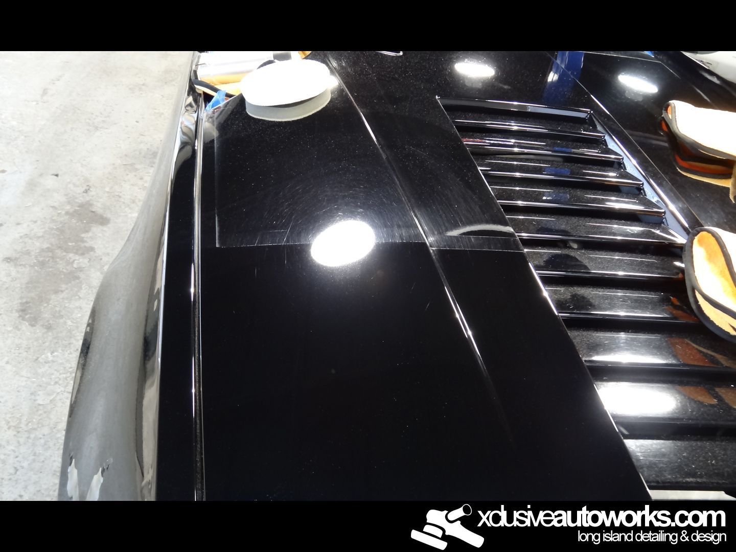 A black car with the website xdusveautoworks.com at the bottom