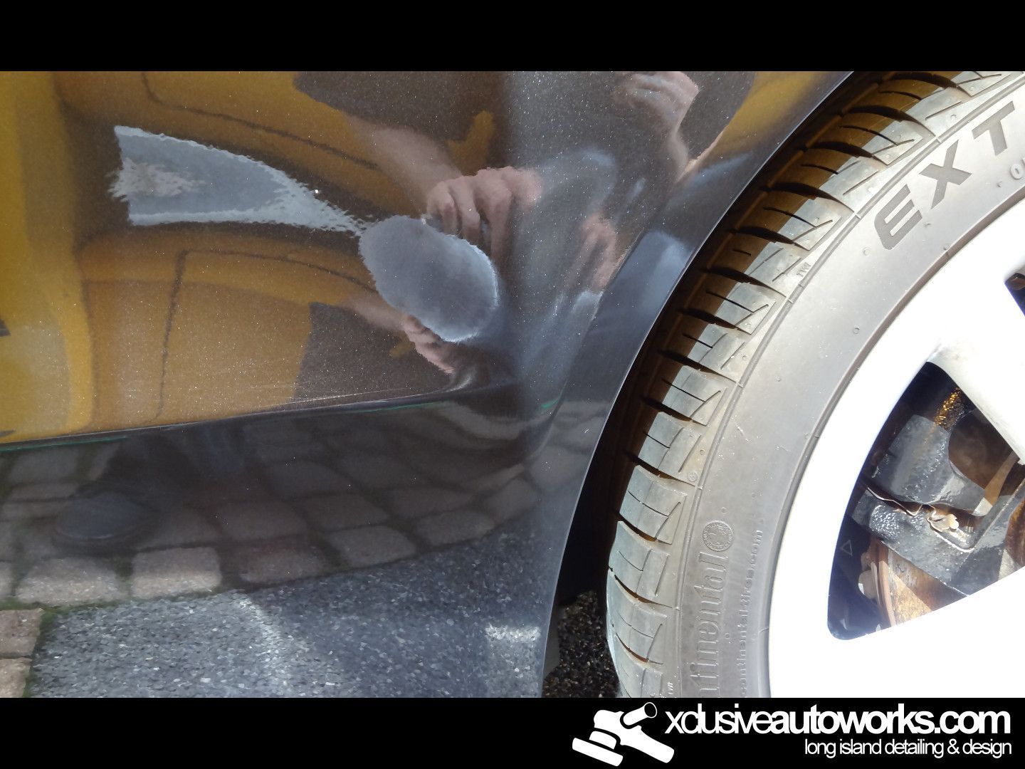 A close up of a tire with the website xdusveautoworks.com on the bottom