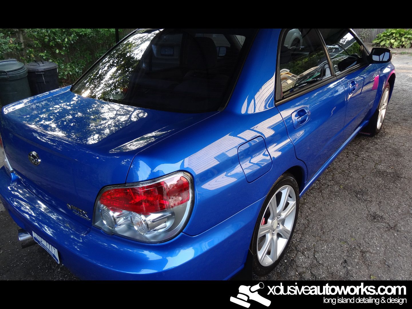 A blue car with the website xdusveautoworks.com at the bottom