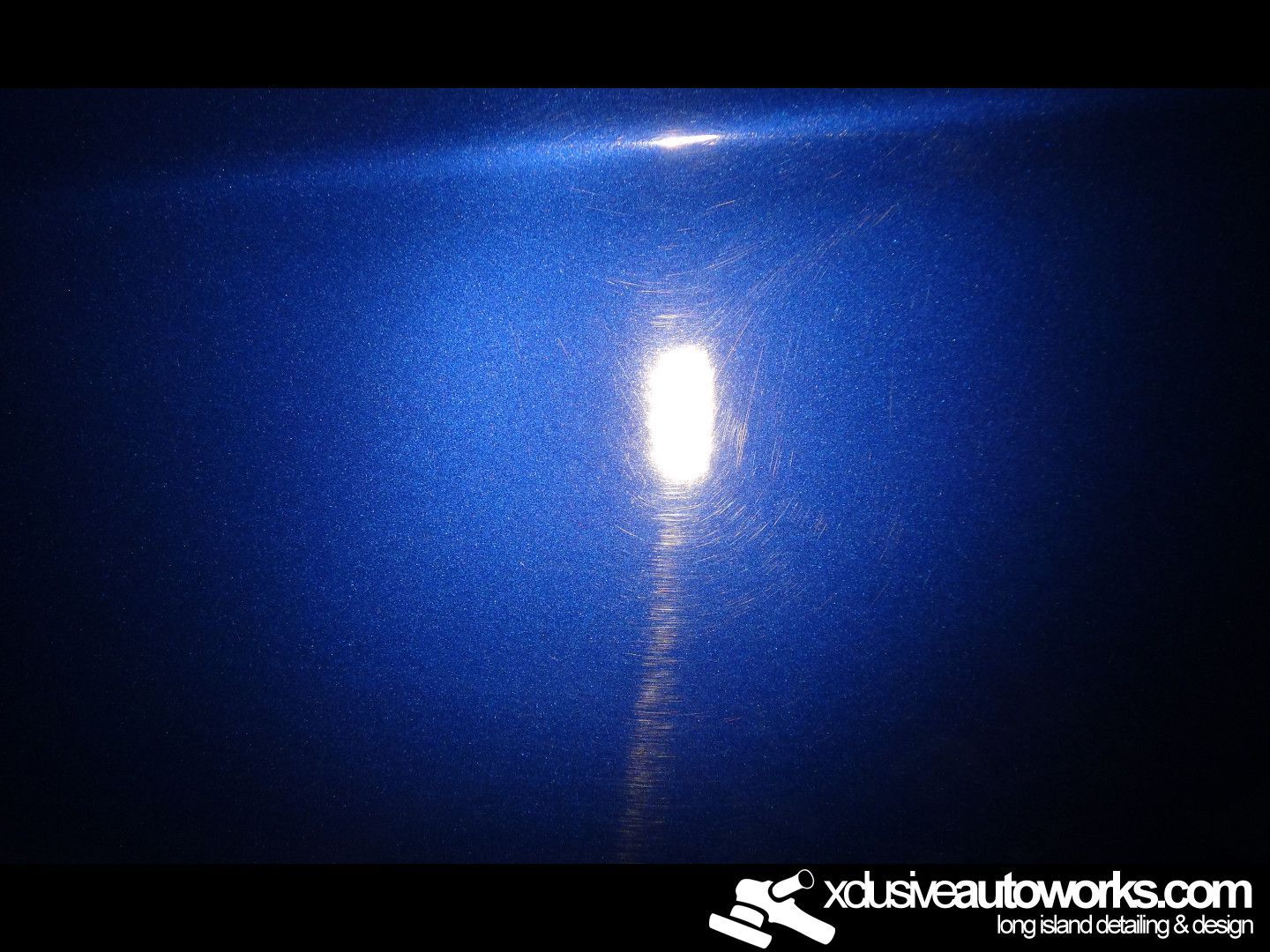 A close up of a blue car with a light coming out of it.