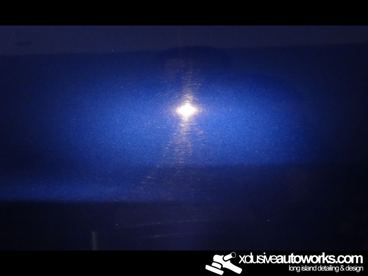 A close up of a blue car with a light coming out of it.