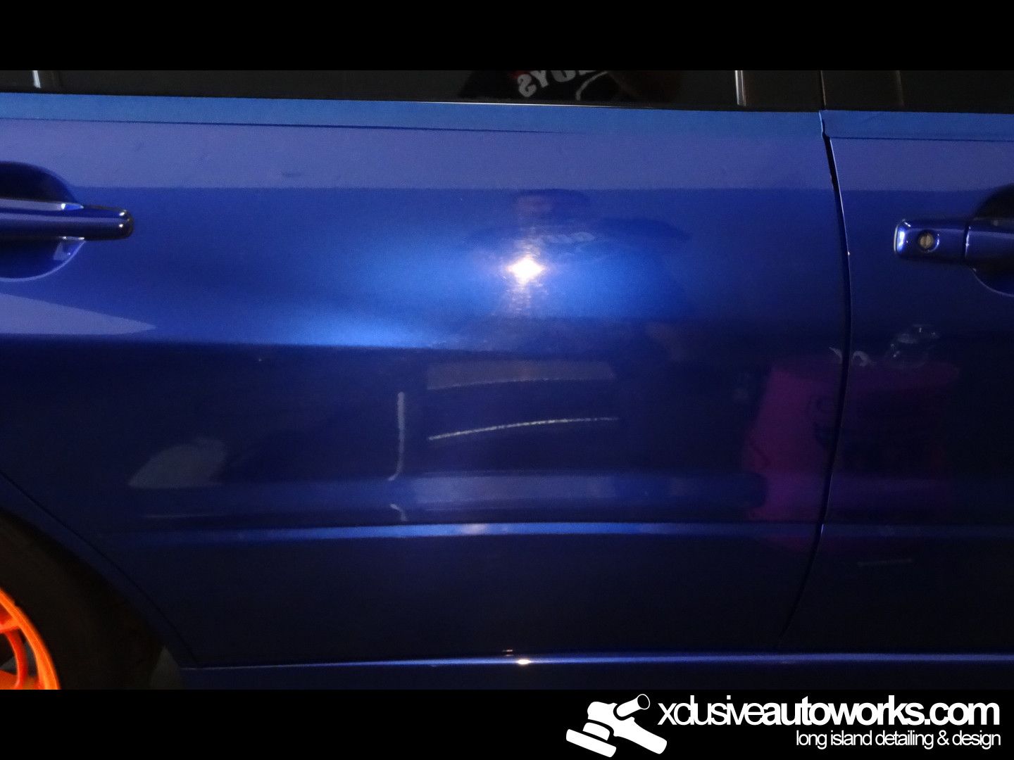 A blue car with the website xdusveautoworks.com on the bottom