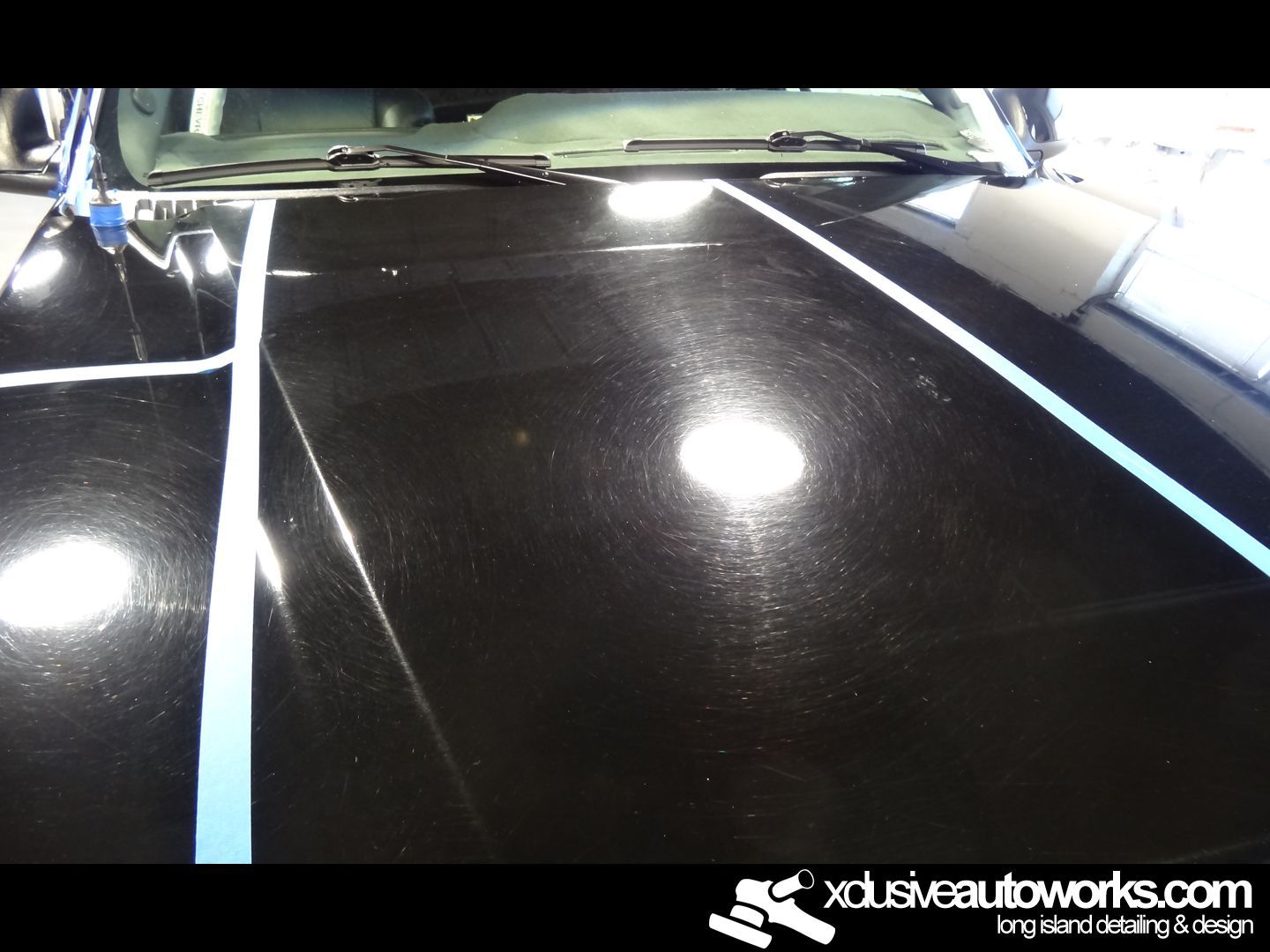A black car is being polished by xdusveautoworks.com