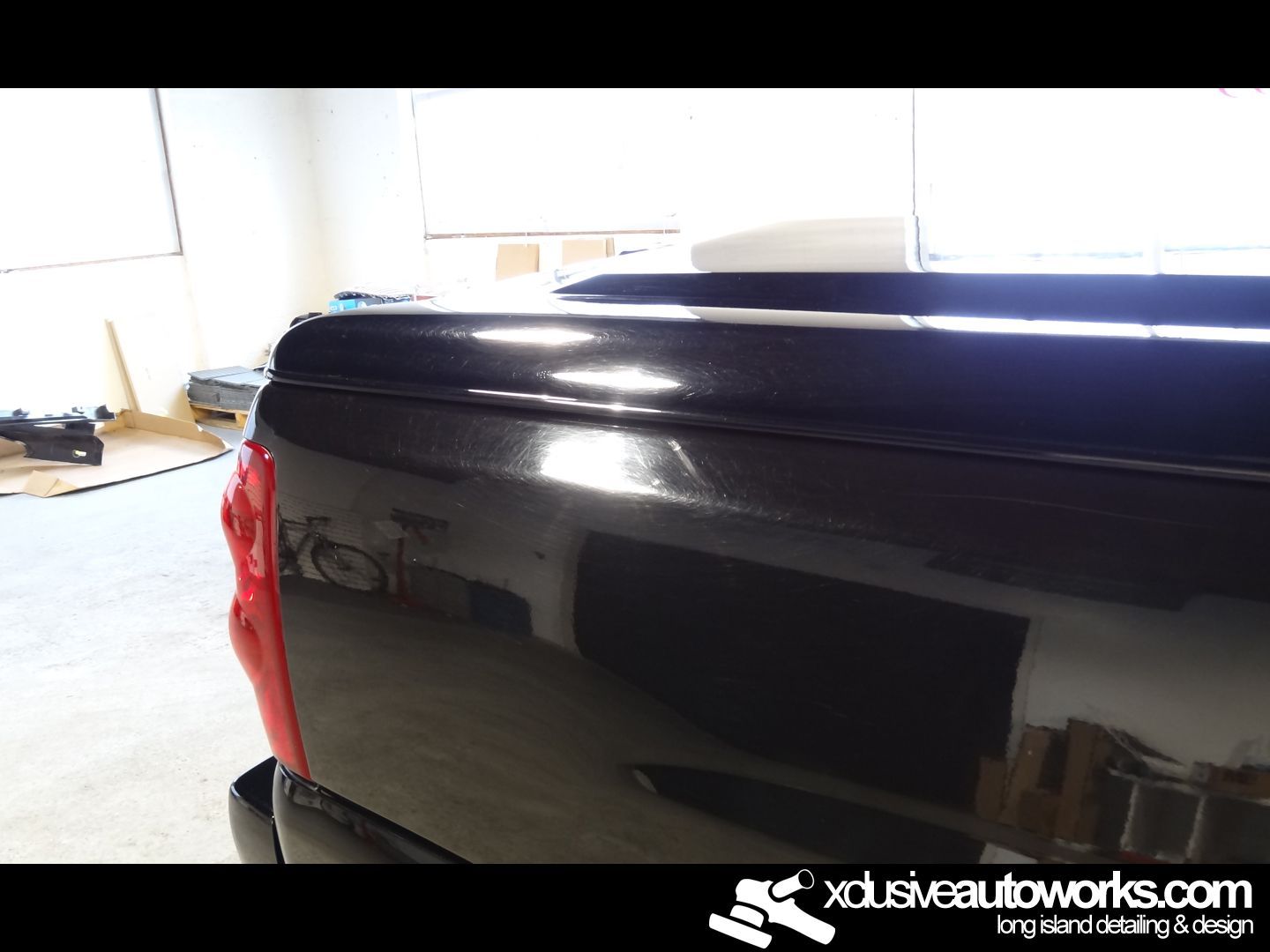 A black truck with the website xdusveautoworks.com on the bottom