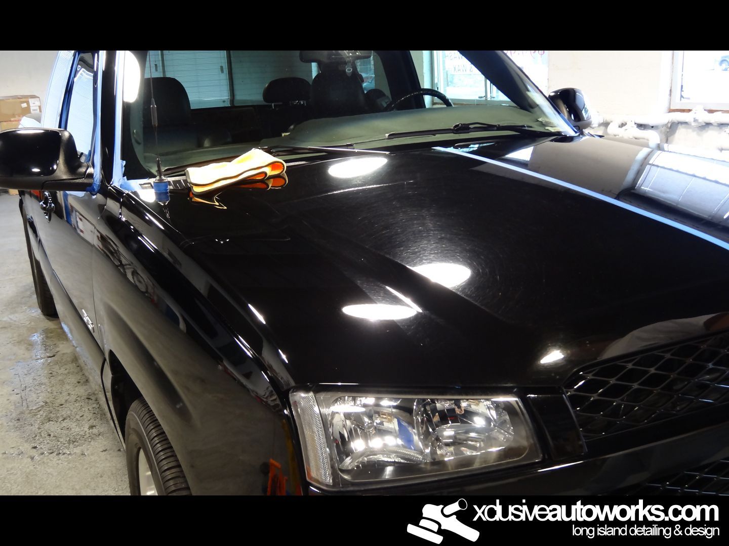 A black truck with the website xdusveautoworks.com on the bottom