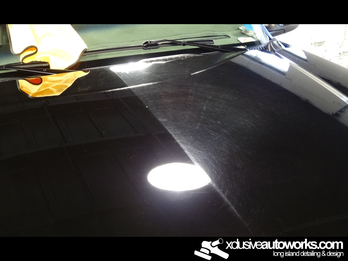 A black car is being polished by xdusveautoworks.com