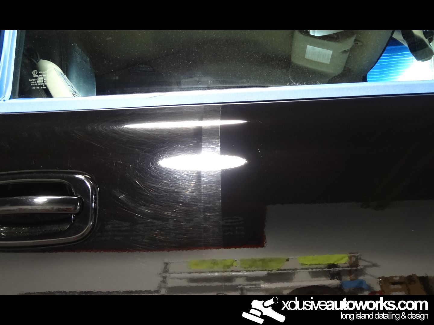 A black car is being polished by xdusveautoworks.com
