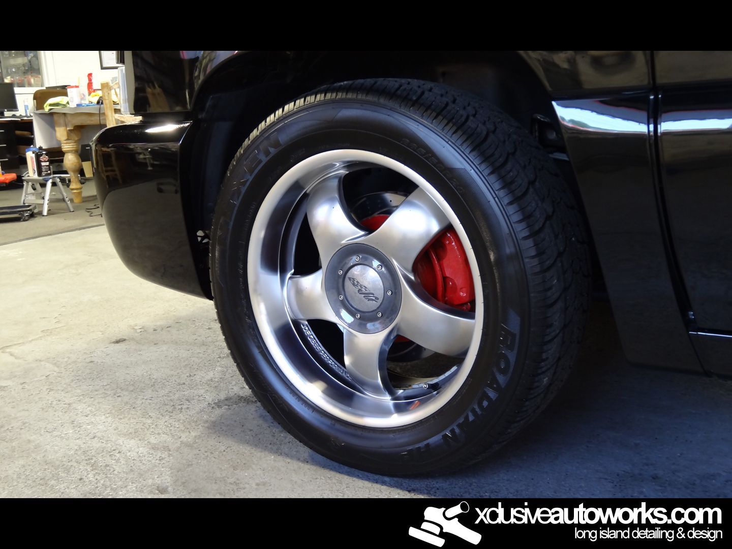 A close up of a car wheel with xdusveautoworks.com written on the bottom