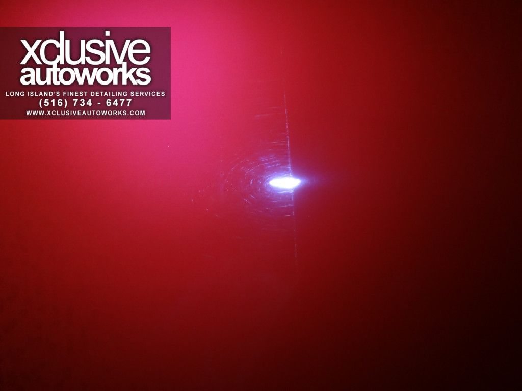 A red background with a logo for xclusive autoworks