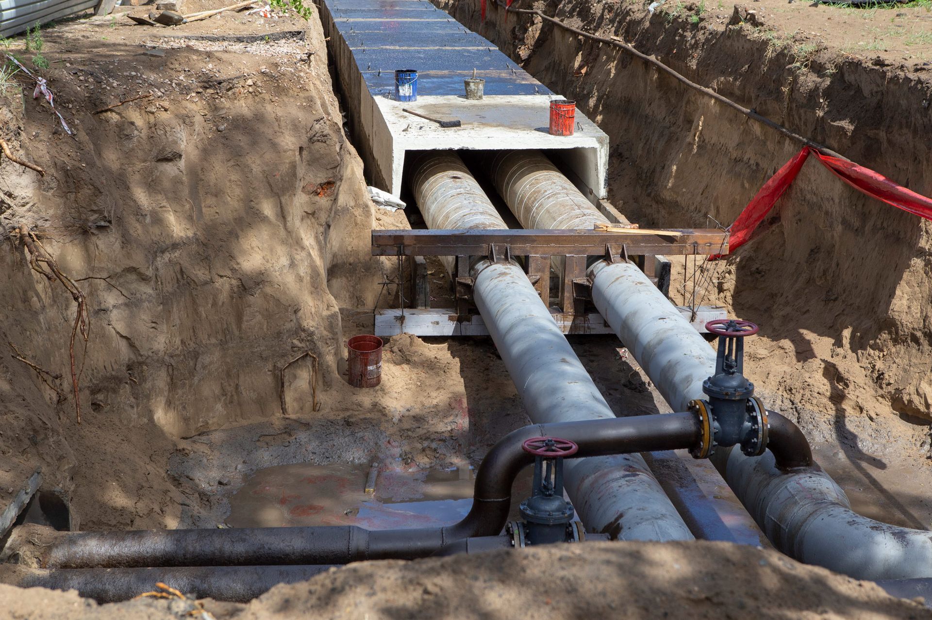 A row of pipes are being installed in a trench.