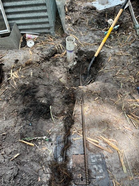 A person is digging a hole in the ground with a shovel.