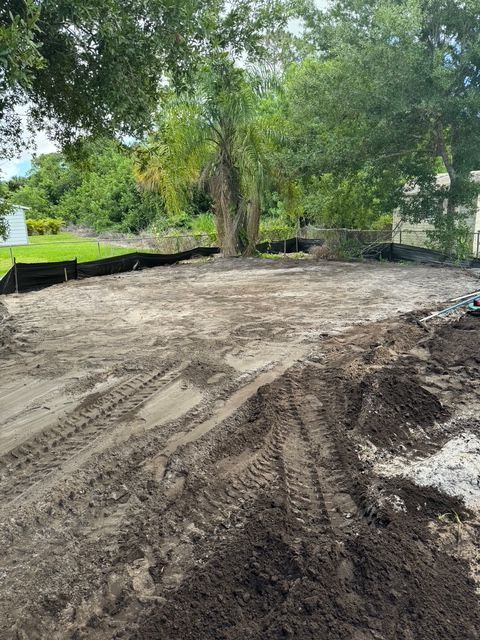 A dirt road with a lot of dirt and trees in the background.
