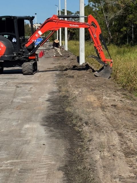 A red and black excavator with the word kubota on it