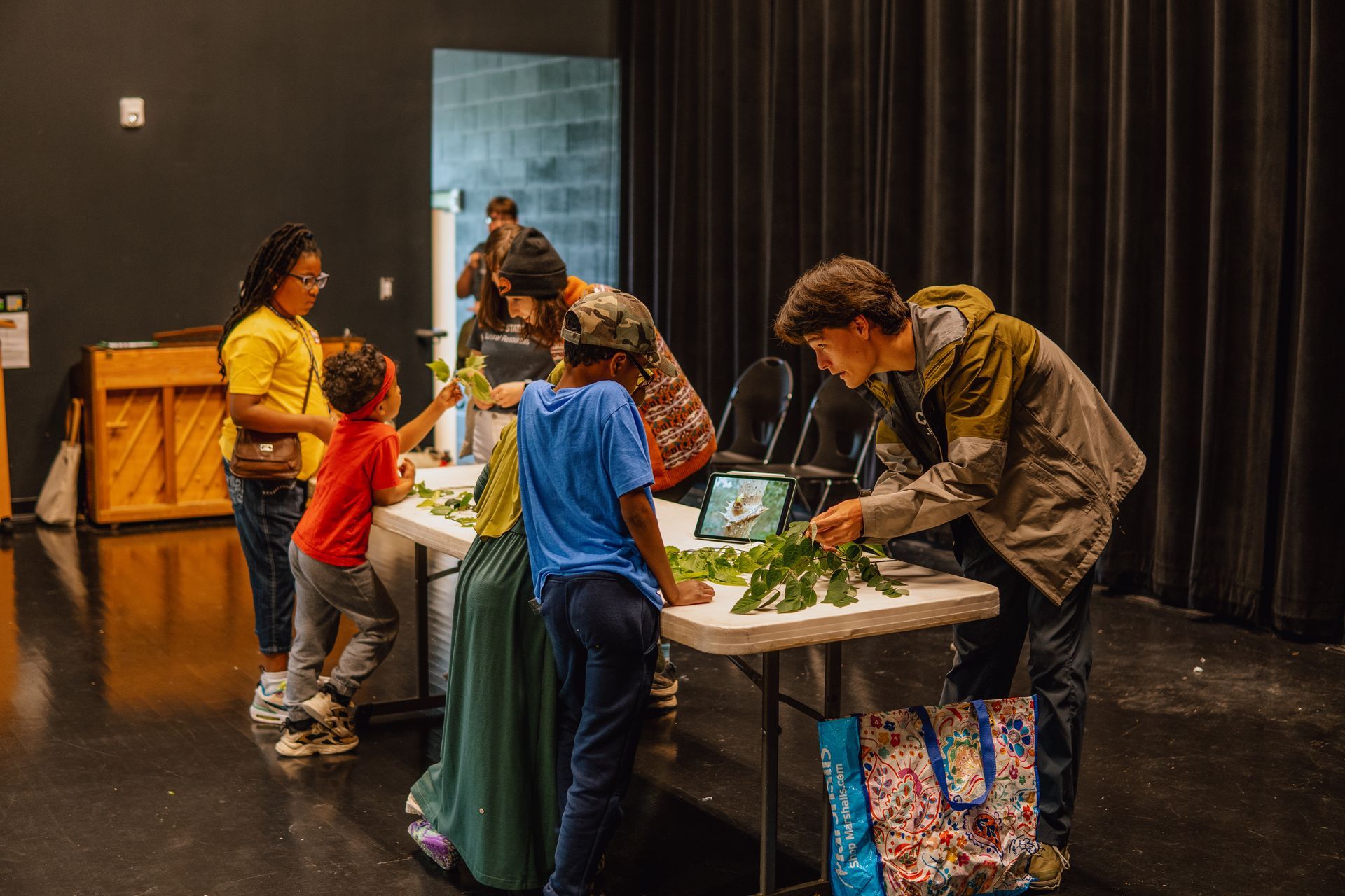 A group of people are standing around a table in a room.