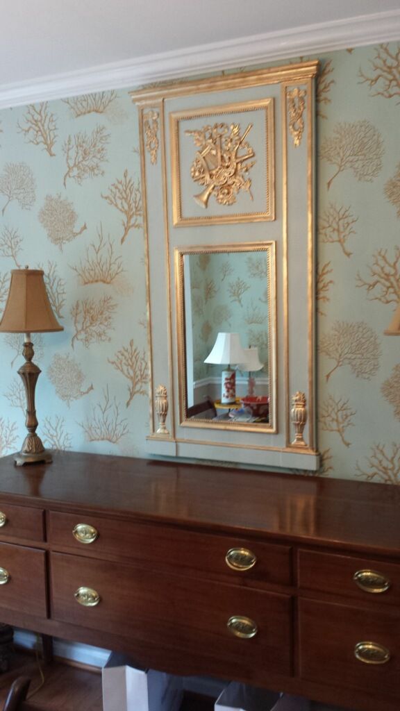 A room with a dresser and a mirror on the wall
