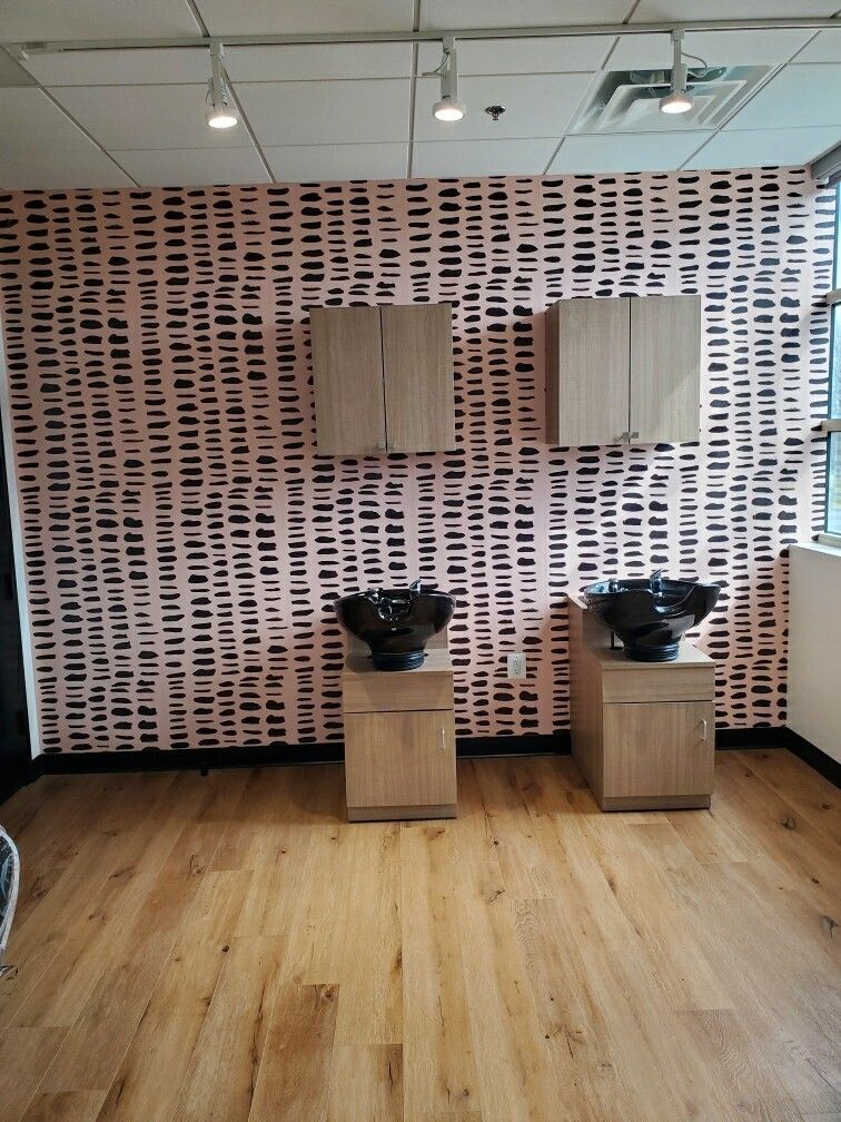 Two sinks in a room with a pink wall