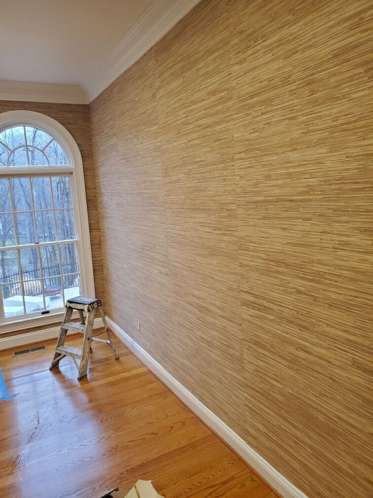 A room with a large window and a ladder on the floor.