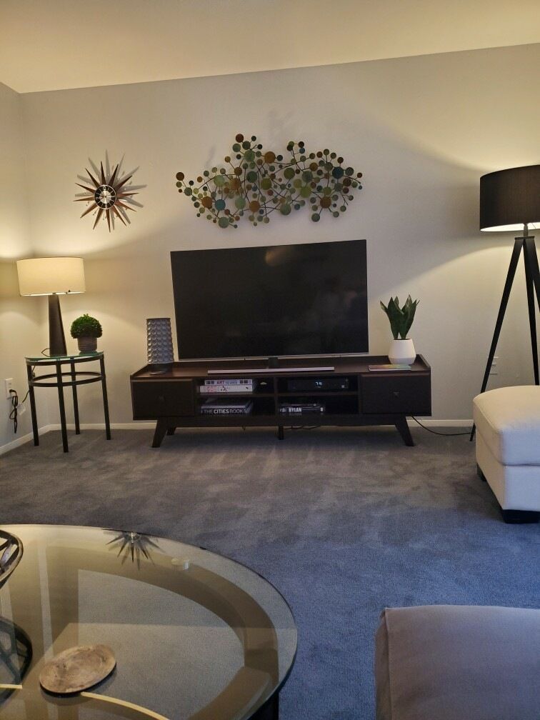 A living room with a flat screen tv on a stand