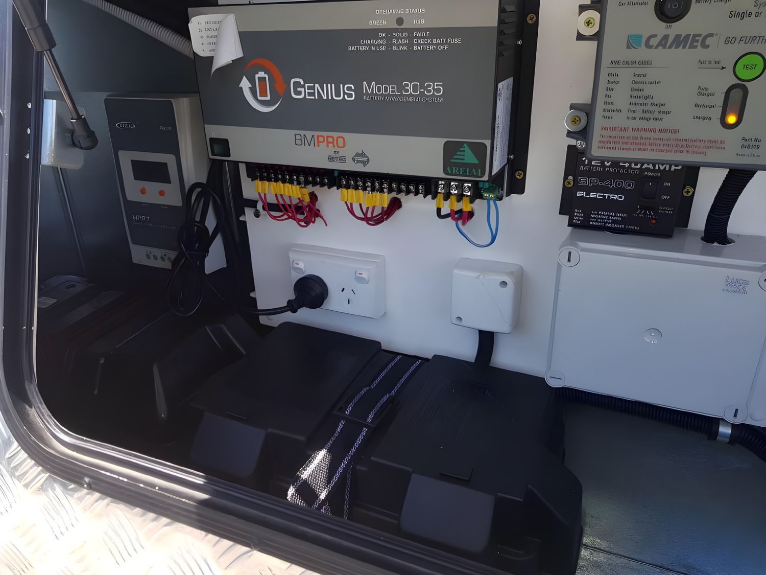 Inside a Cabinet, a Genius Multi 30-35 Battery Charger, Camec Control Panel, and Other Electrical Components Are Mounted With a Battery Below — Shannon's Auto Electrical in Garbutt, QLD