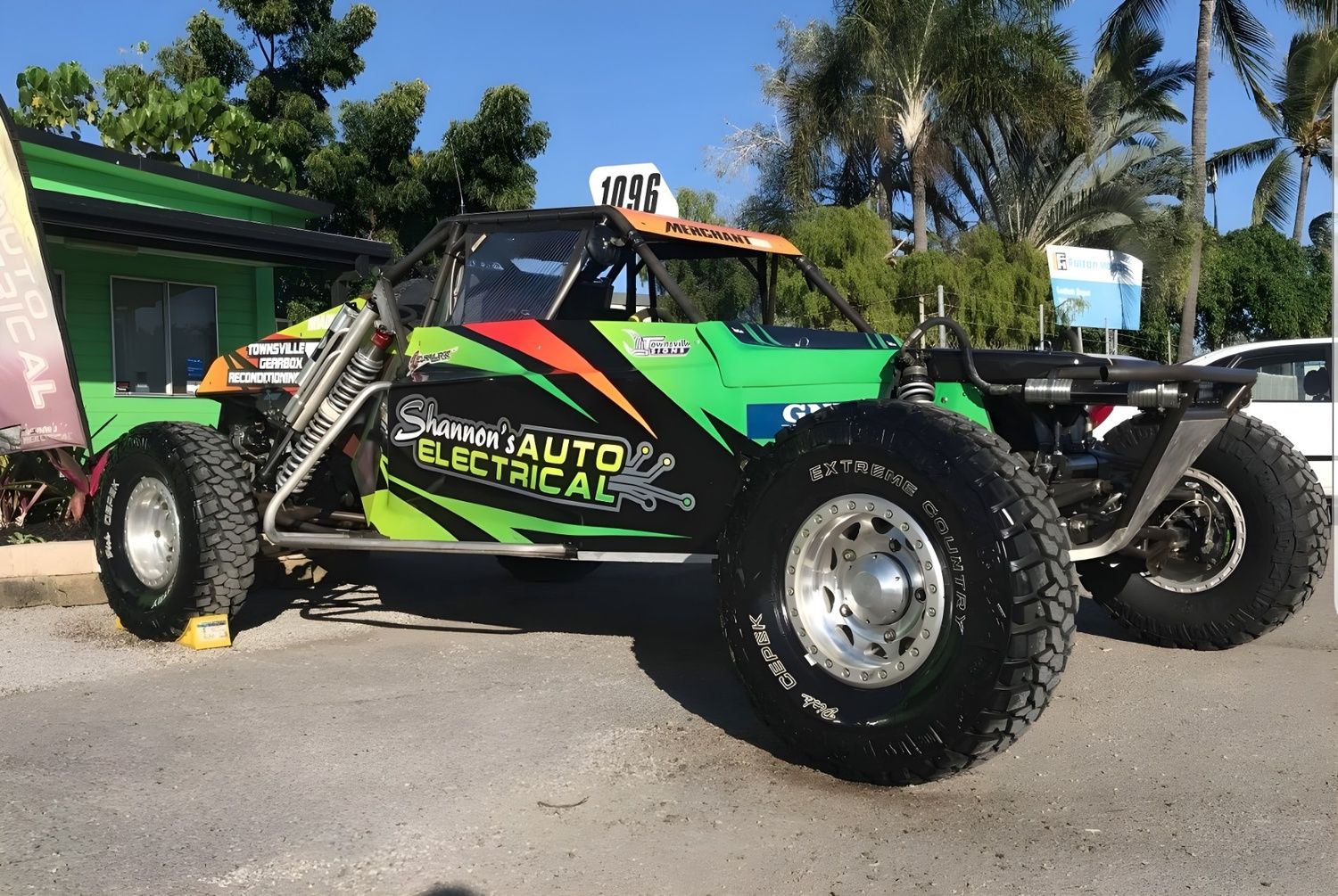 Green Off-road Race Car With Sponsor Logos Parked on a Paved Surface — Shannon's Auto Electrical in Garbutt, QLD
