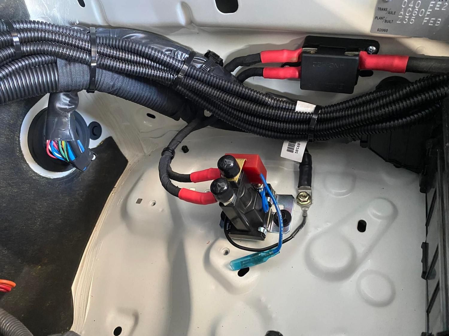 Electrical cOmponents in a Vehicle's Engine Bay; Includes Cables, a Relay, and Wiring. the Setting is a White Compartment — Shannon's Auto Electrical in Garbutt, QLD
