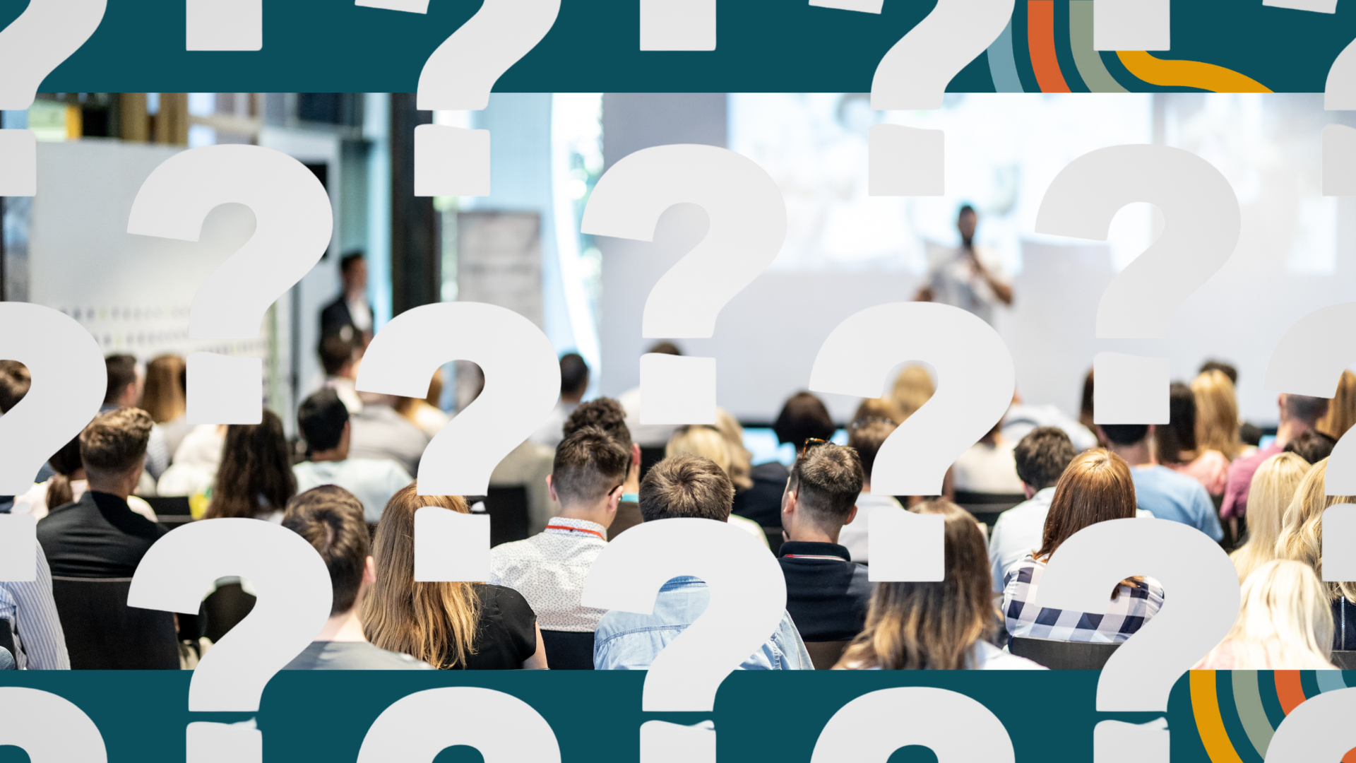 A group of people are sitting in a room with question marks on the wall.