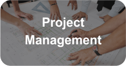 A group of people are sitting around a table looking at a blueprint ..