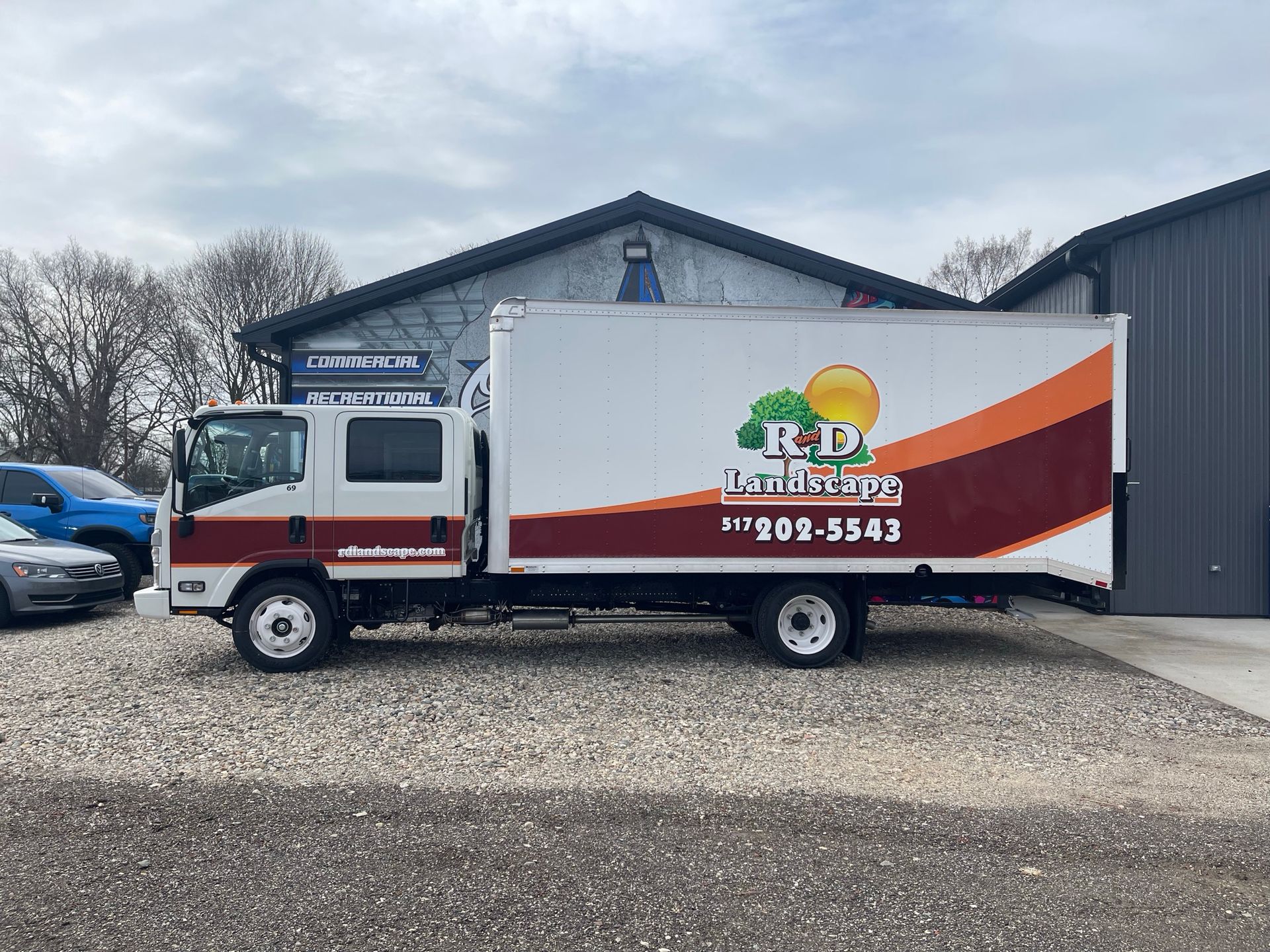 A red ford truck is parked on the side of the road