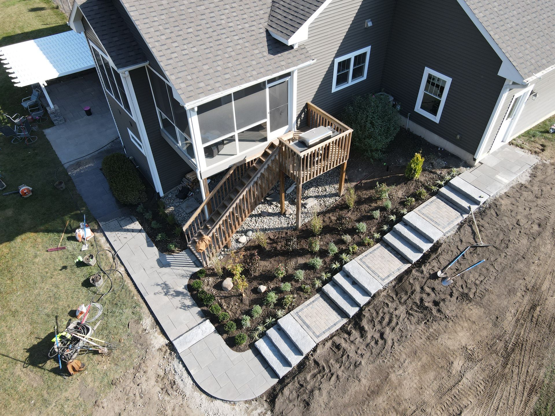 An aerial view of a house with a walkway leading to it