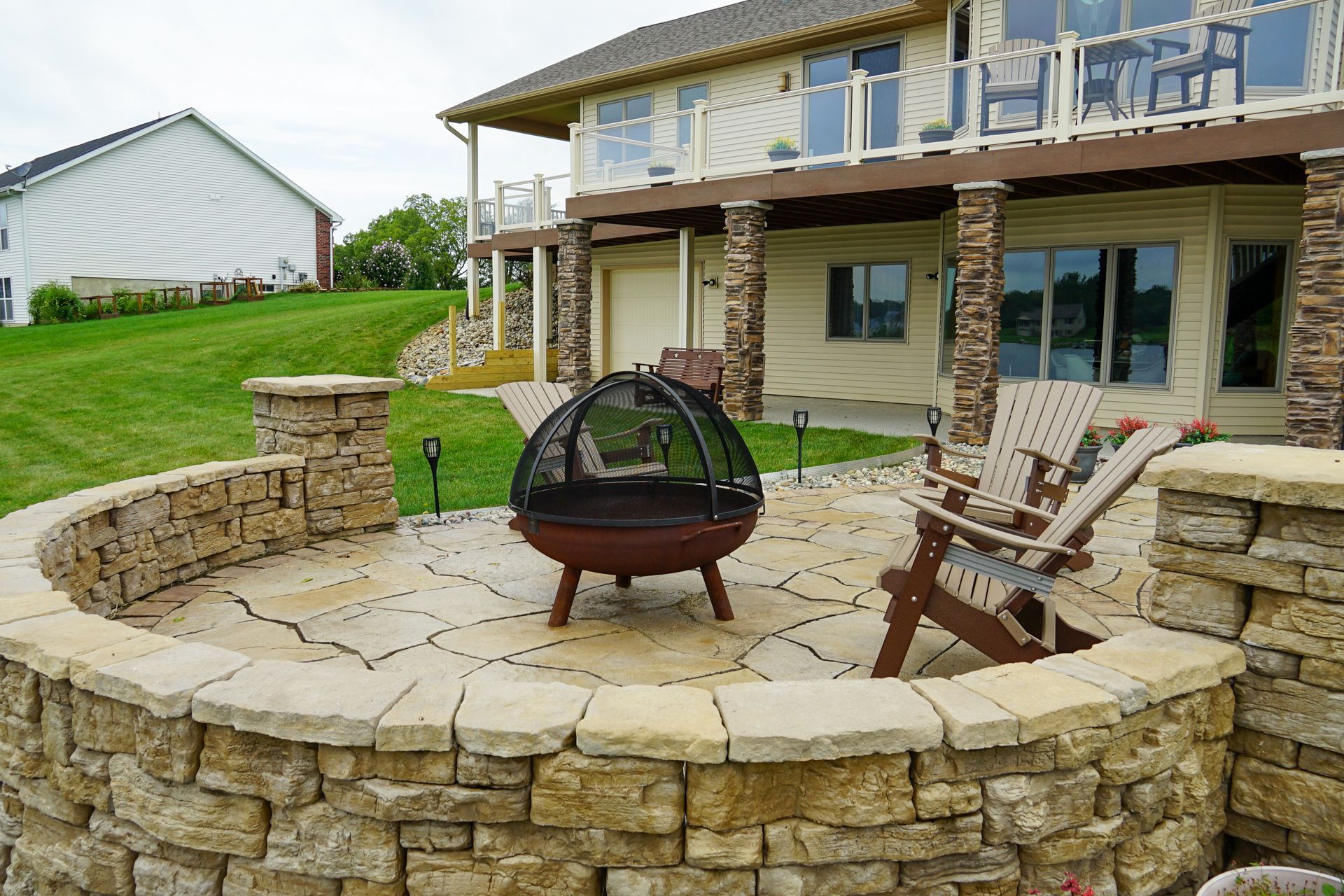 There is a fire pit in the middle of the patio.