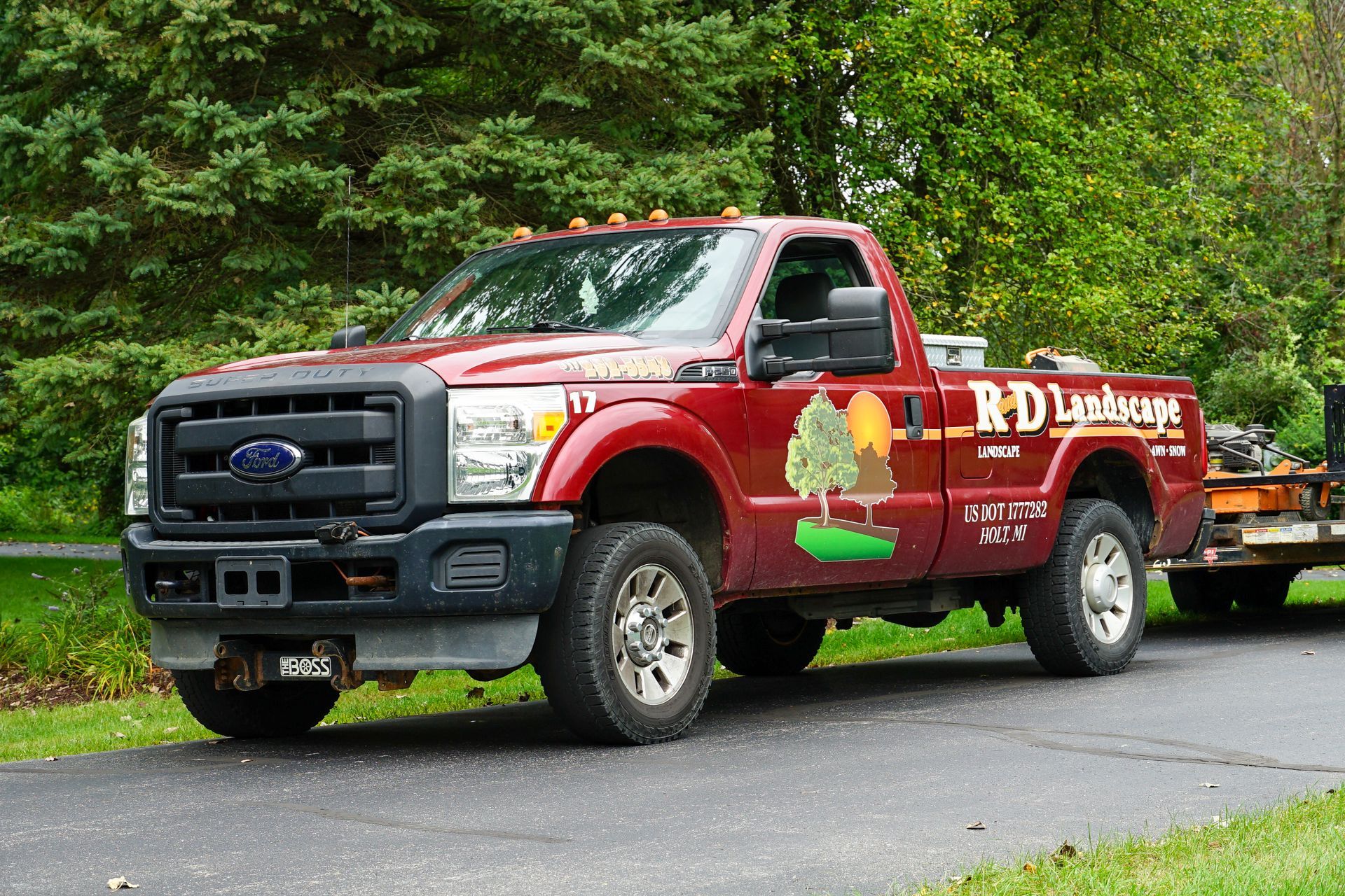 A red ford truck is parked on the side of the road