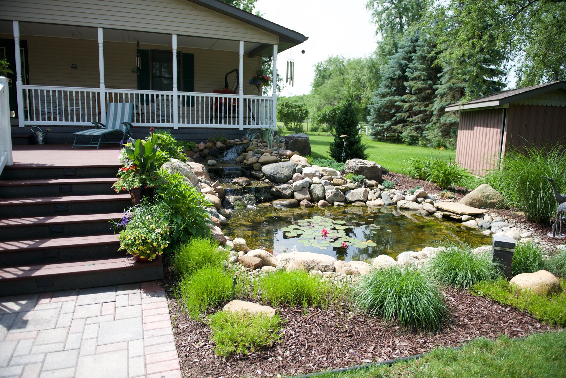 An american flag is flying in front of a pond