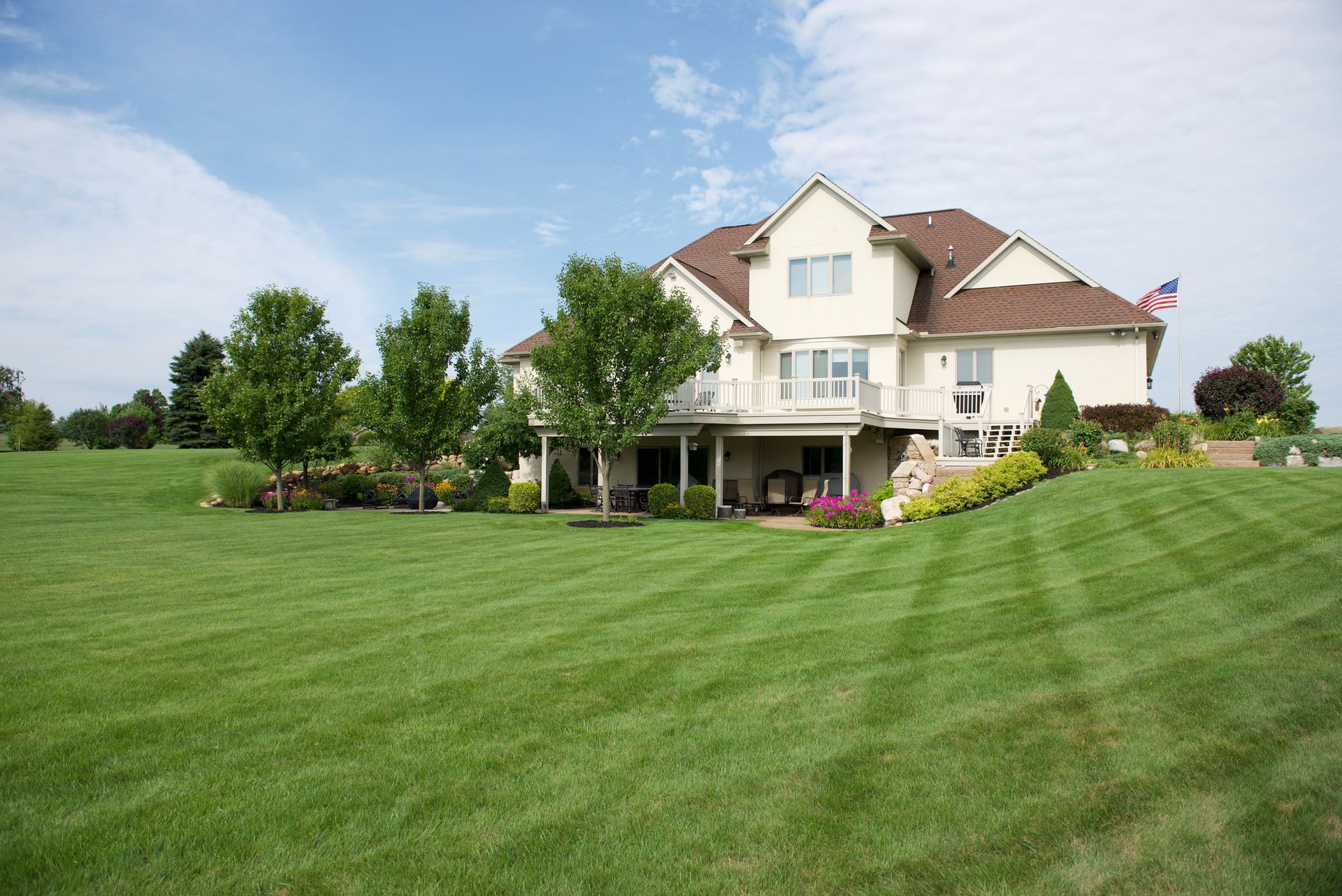 A large house with a lush green lawn in front of it.